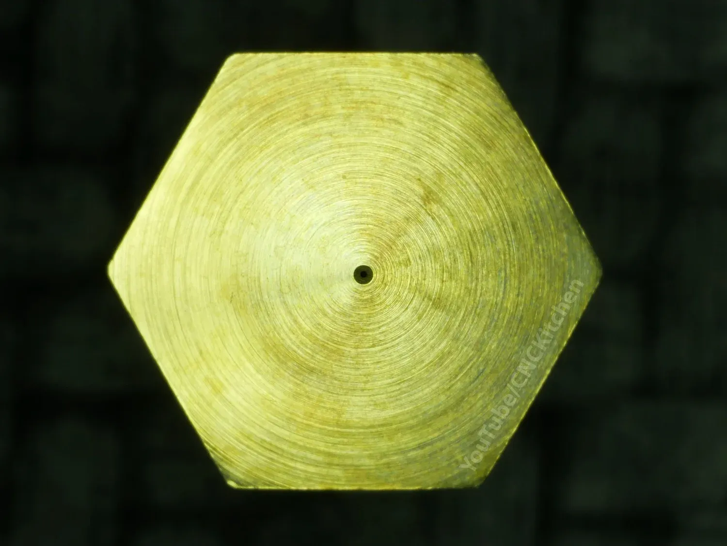 The flat of the tip head-on, the orifice a dot in the middle of the concentric turning marks