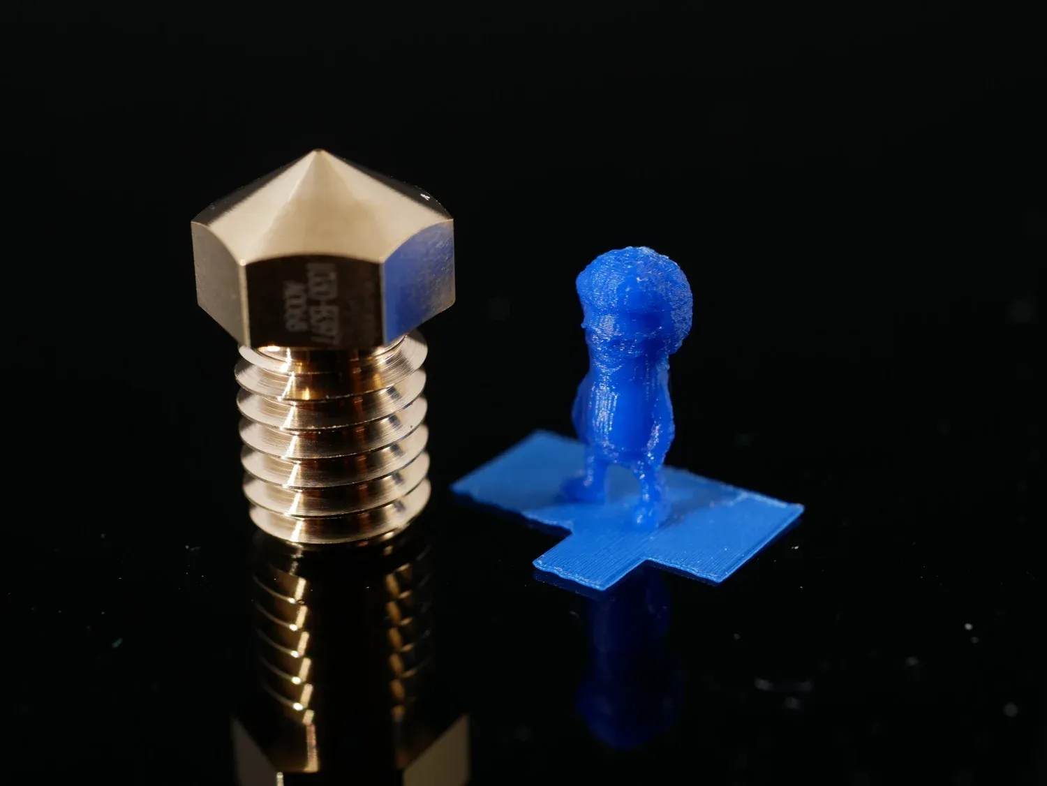 A quarter-scale Marvin printed with the 0.1 mm nozzle, barely taller than the nozzle beside it