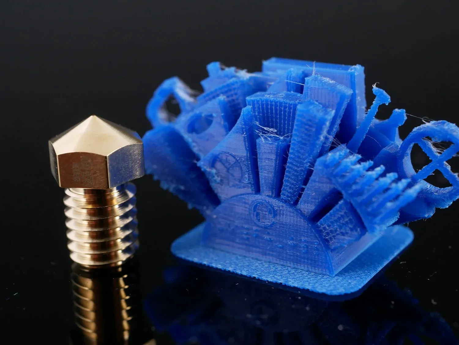 A detailed all-in-one test print, its towers and rings resolved but tangled in support material