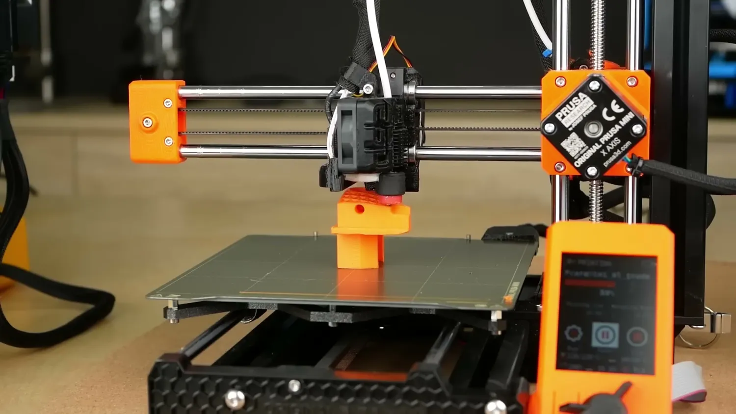 Prusa Mini printing an orange part layer by layer