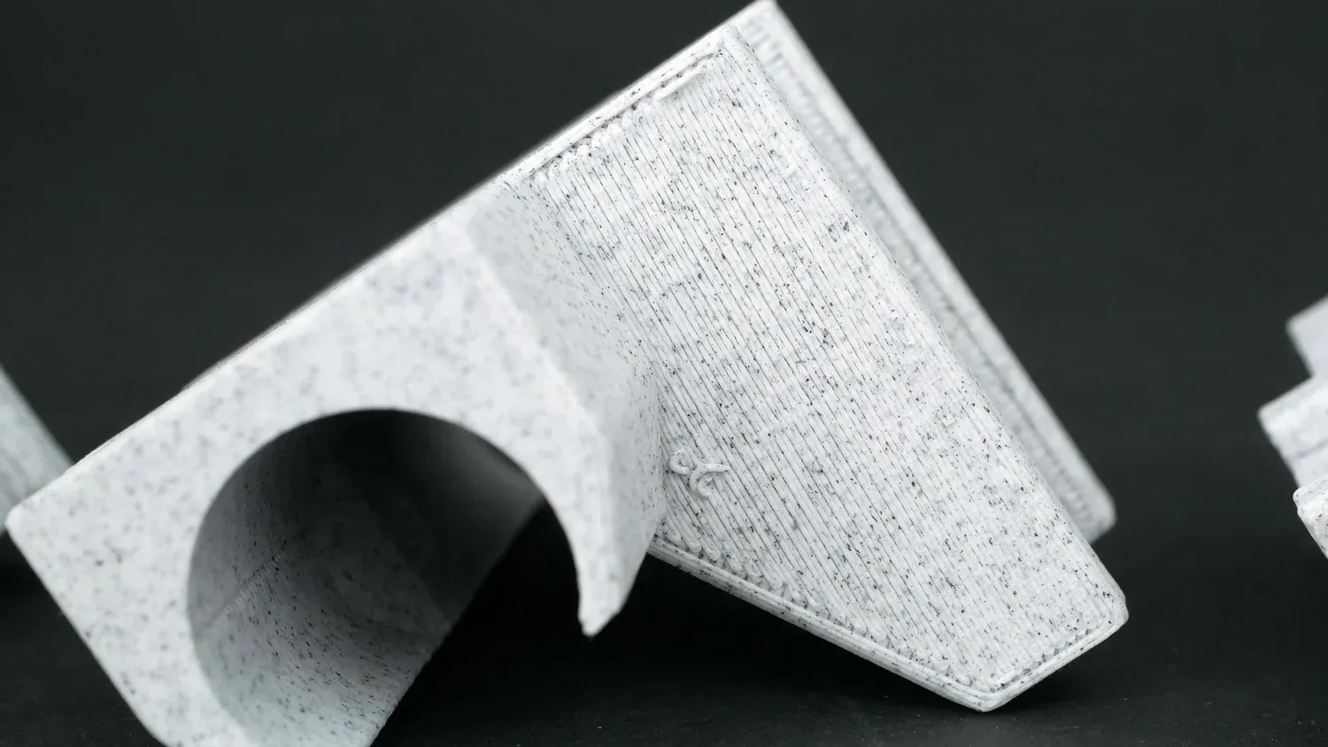 The overhang test part printed with supports, its underside solid but scarred where the supports were removed