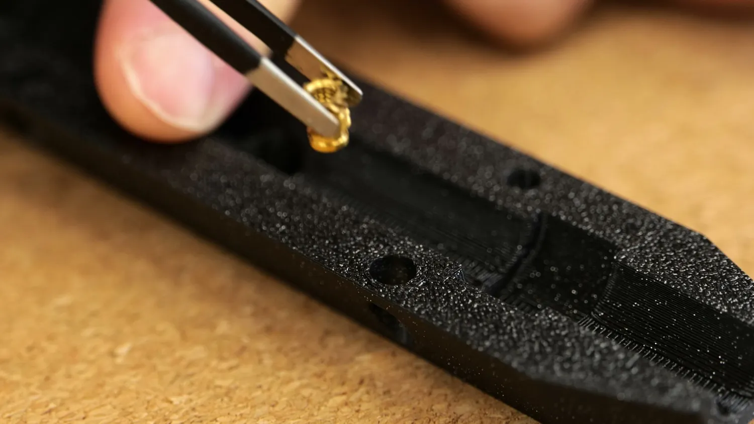 Pre-seating a heat-set insert into a 3D-printed part with tweezers