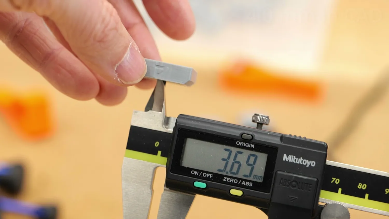 Caliper measuring a 3D-printed test sample
