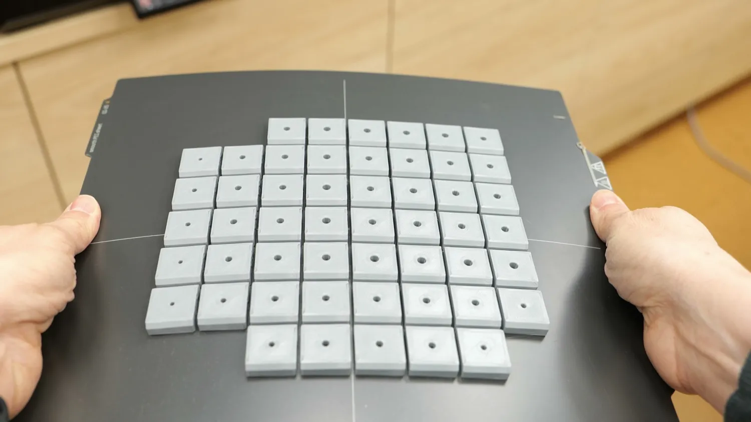 A full build plate of printed heat-set insert test samples