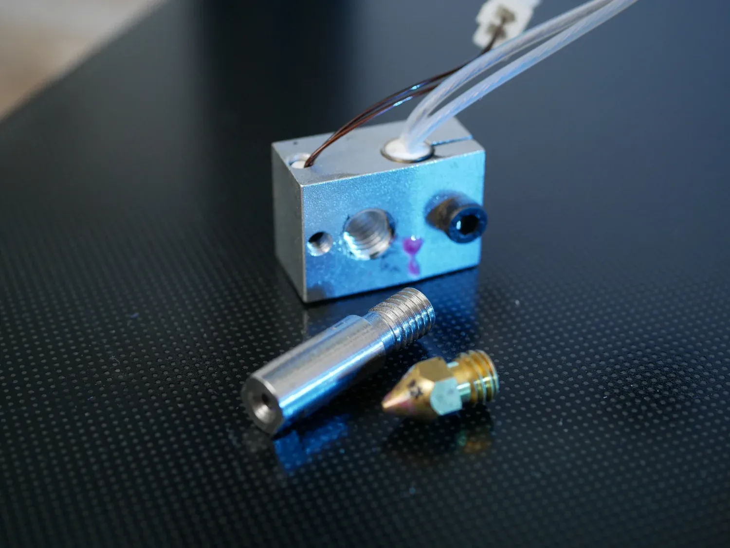 The heater block with the heat break and brass nozzle removed, showing the gap the PTFE leaves