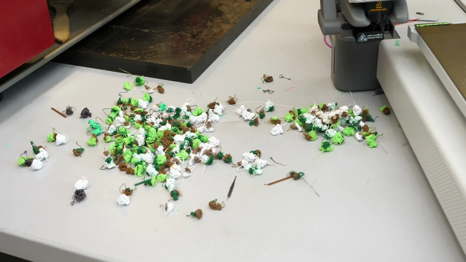 A pile of purged filament blobs on the workbench