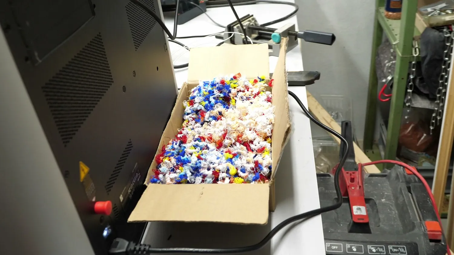 A cardboard box filled with multi-colored purge poop