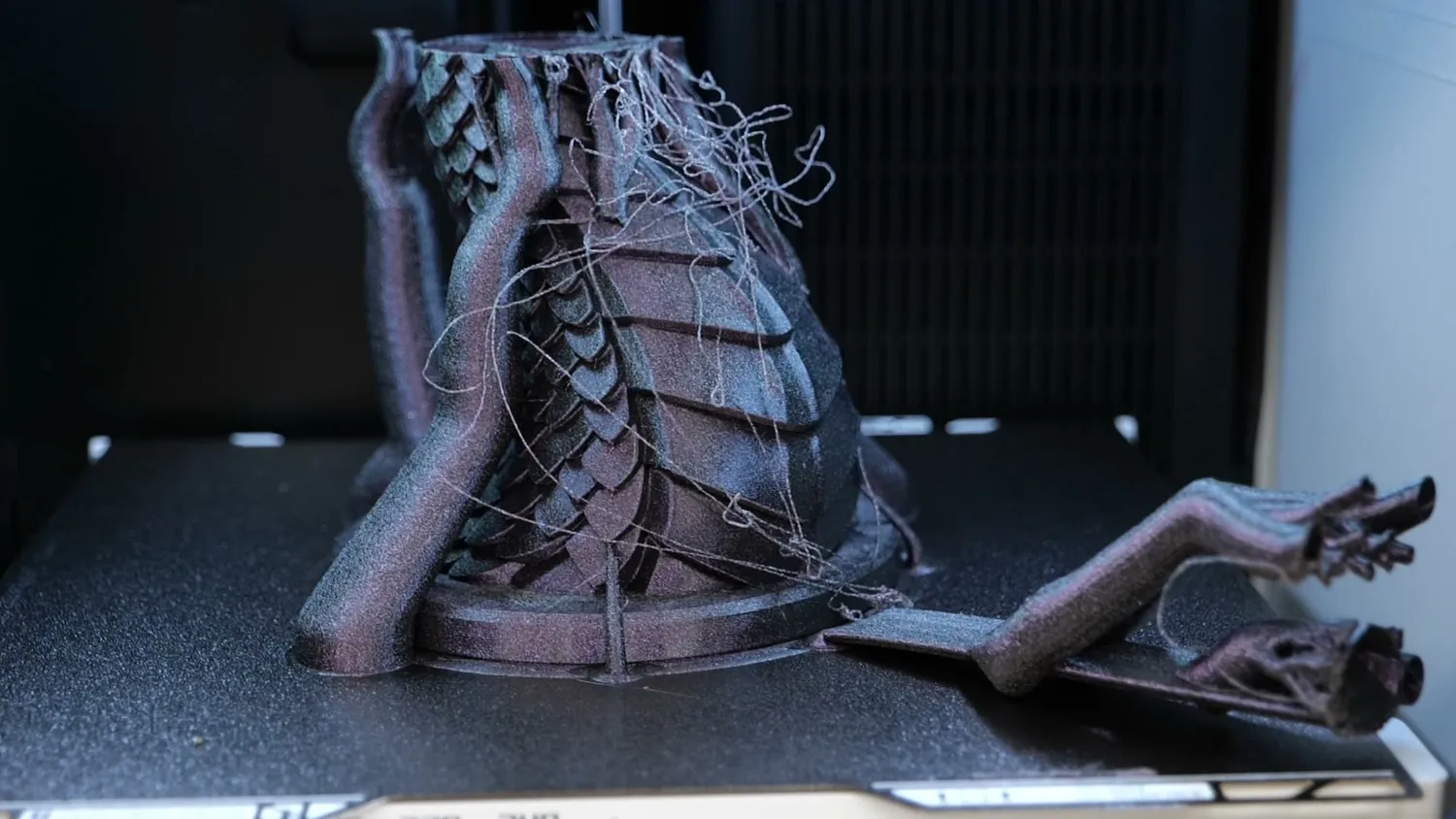 A failed print with collapsed supports and stringing on the build plate