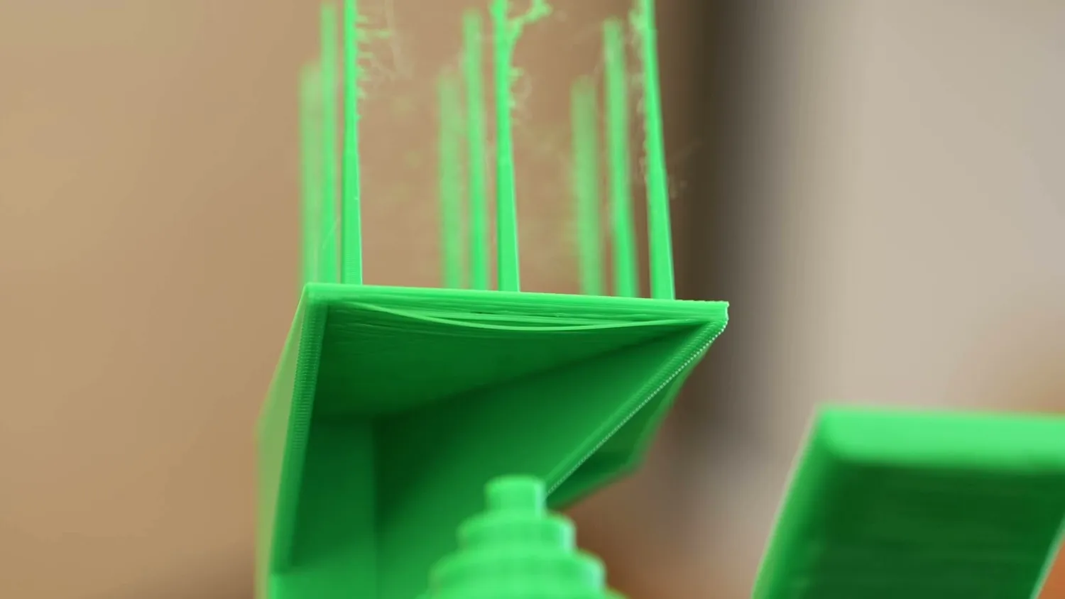 Close-up of green printed spikes covered in fine strings