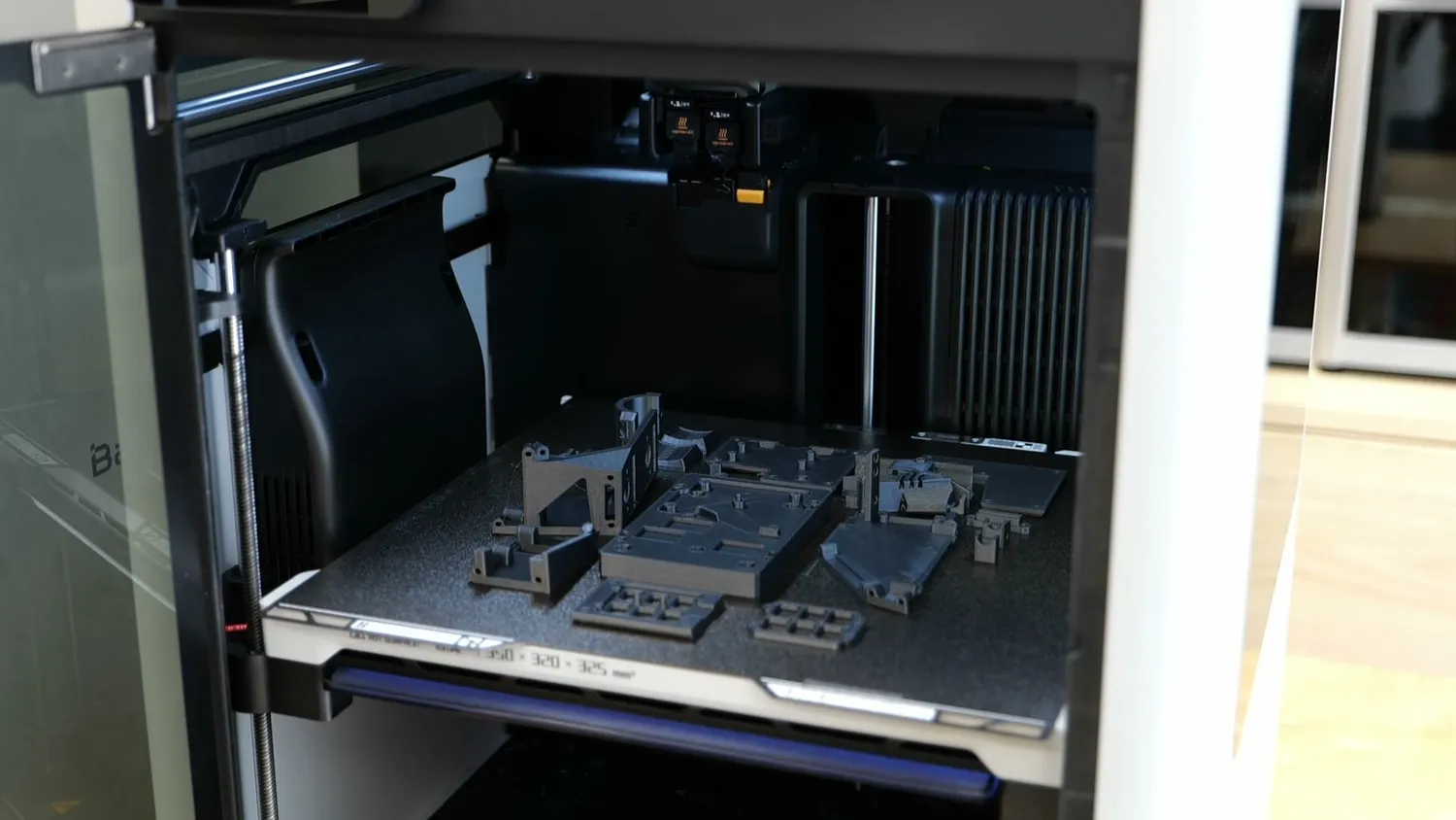 Grey printed Pixelpump parts filling a build plate
