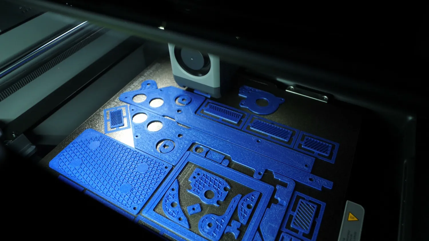 Flat blue parts printing on the P2S build plate under the new chamber lighting