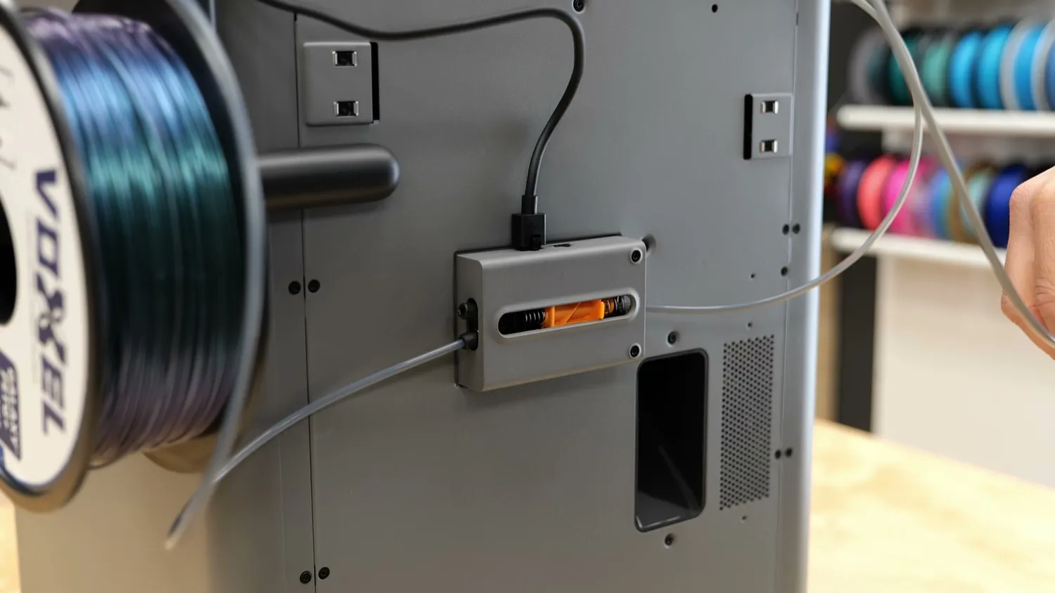 The filament buffer mounted on the back of the P2S with two PTFE inputs