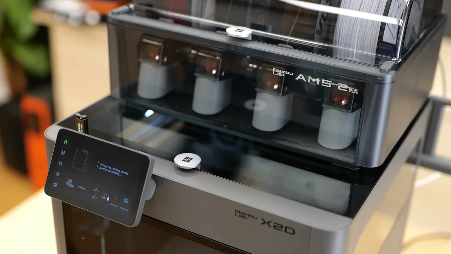 The tiltable touchscreen of the Bambu Lab X2D with the AMS 2 Pro on top