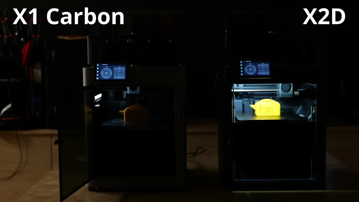 The X1 Carbon and the X2D printing in the dark, showing the brighter X2D chamber lighting