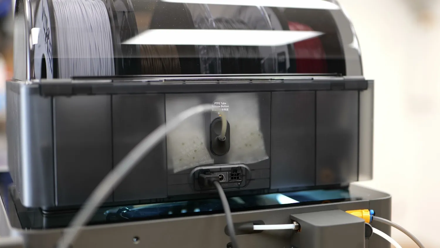 The rear of the AMS 2 Pro with its single PTFE exit port and desiccant bags