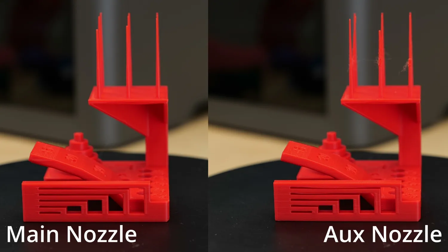 Two identical red test prints compared, one from the main and one from the auxiliary nozzle