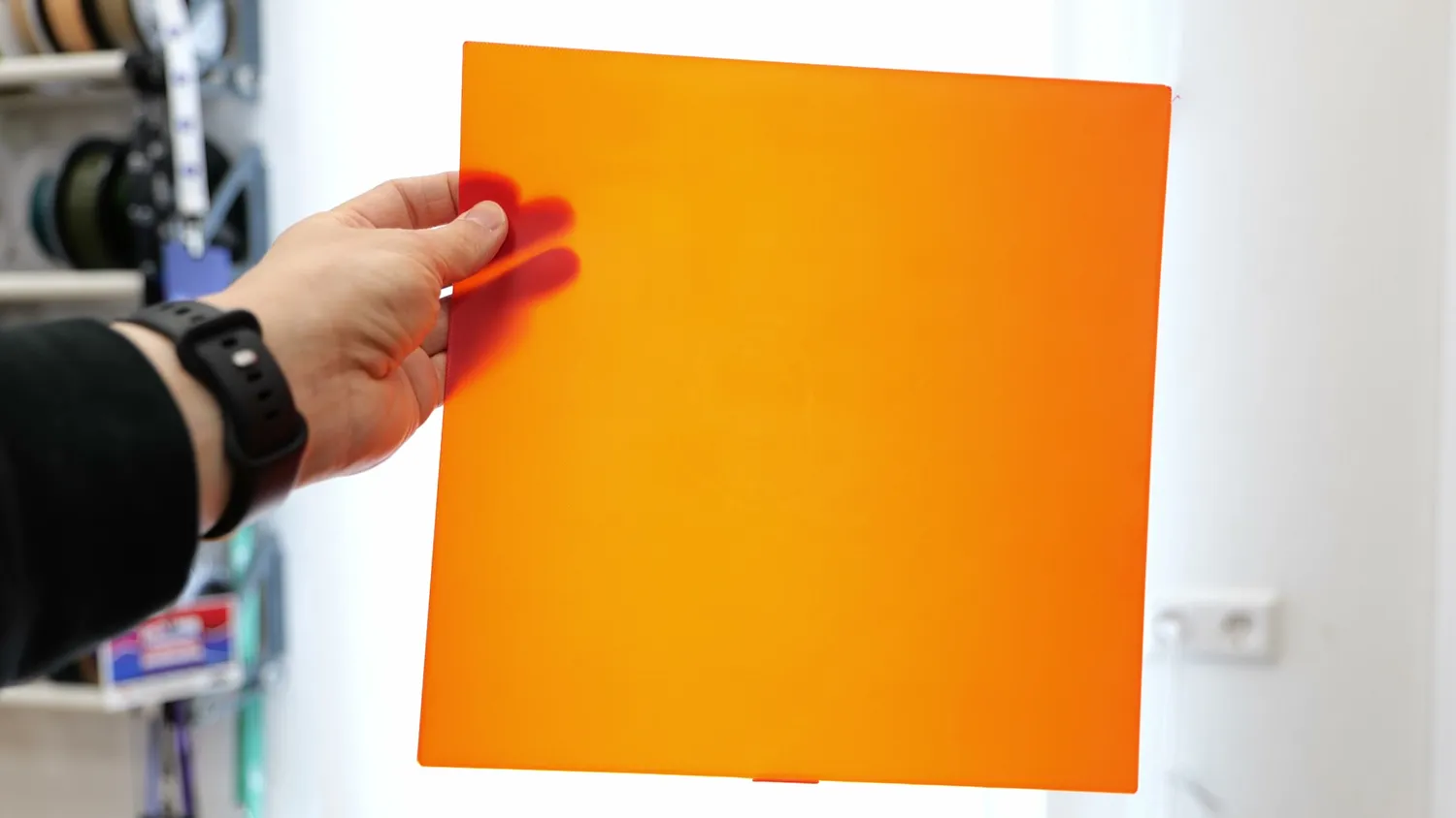 An even orange first layer printed on the smooth sheet, held up to the light