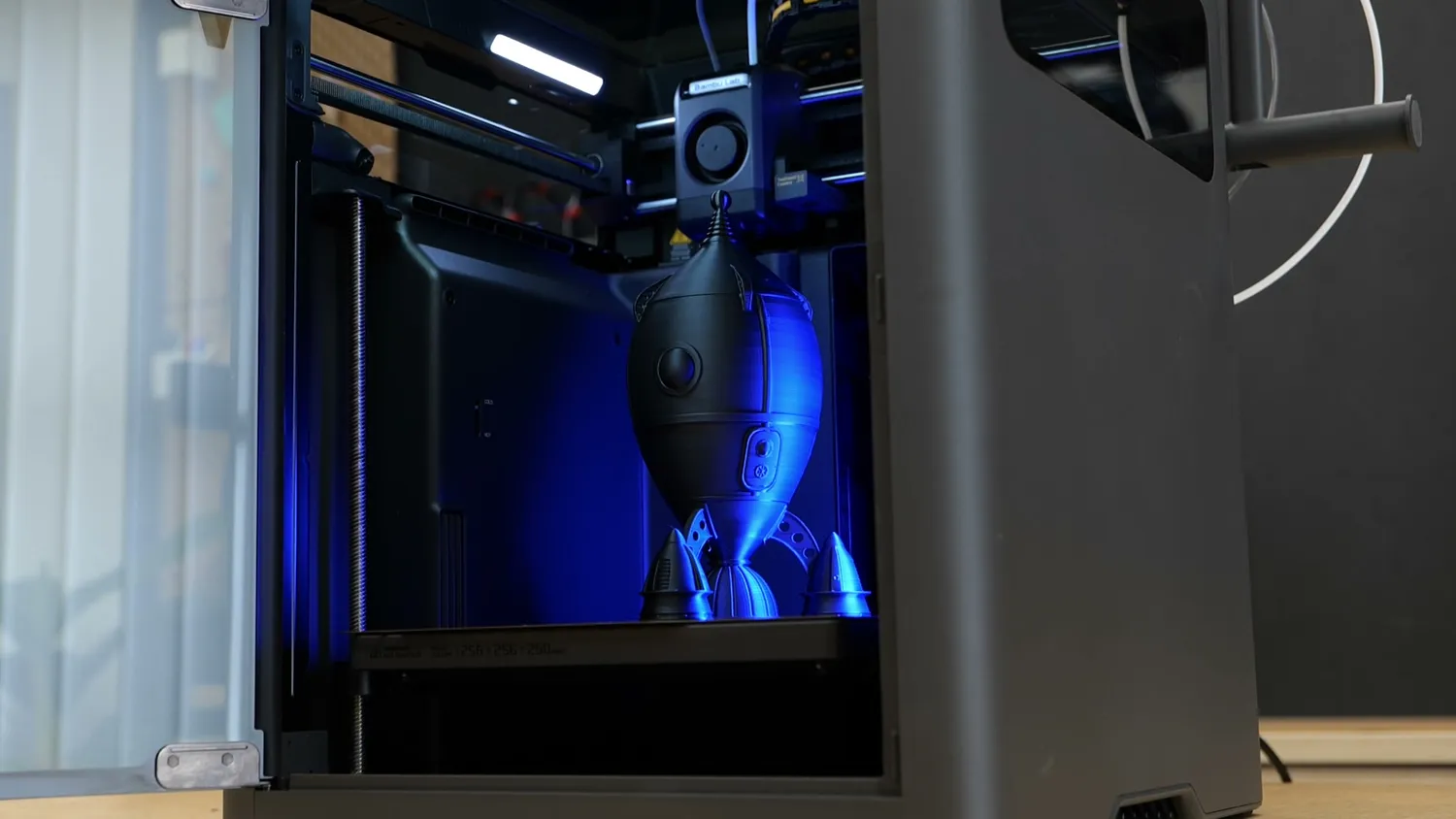 A black retro rocket printed inside the X2D's lit chamber