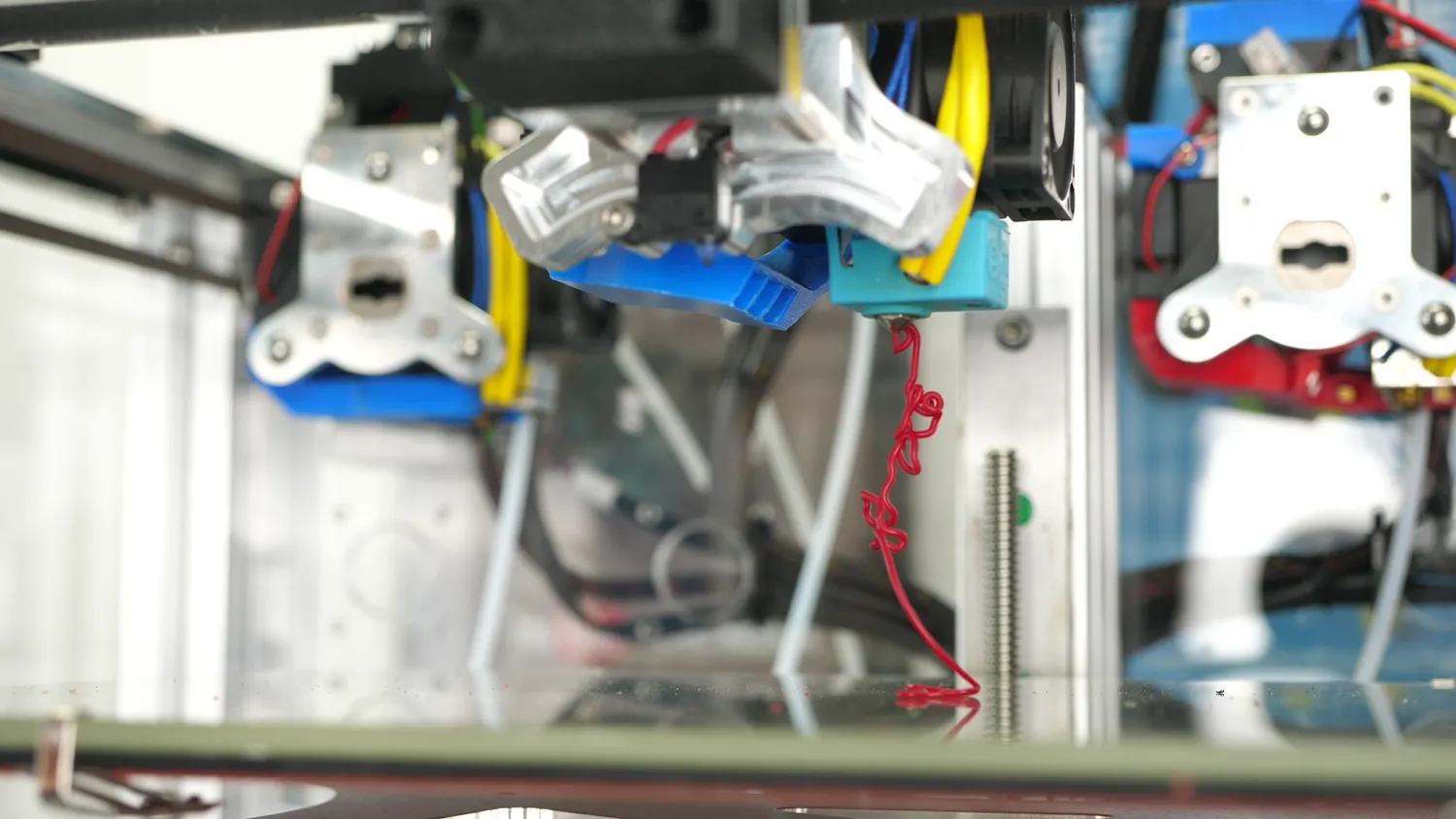 At high speed the strand comes out badly kinked and coiled, the melt inconsistency that marks the limit of the setup