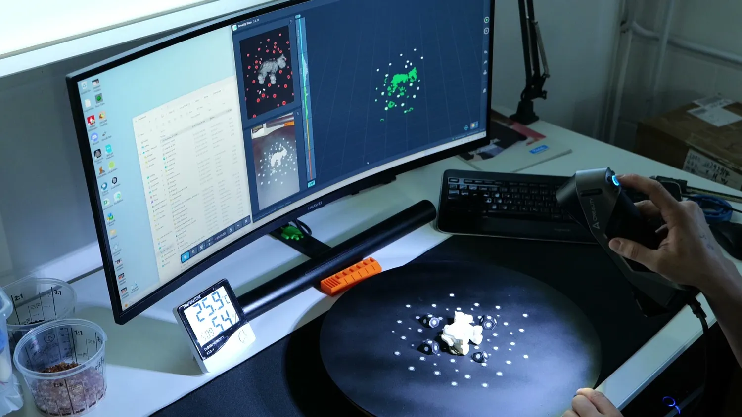 The turntable sitting in front of the monitor at the desk