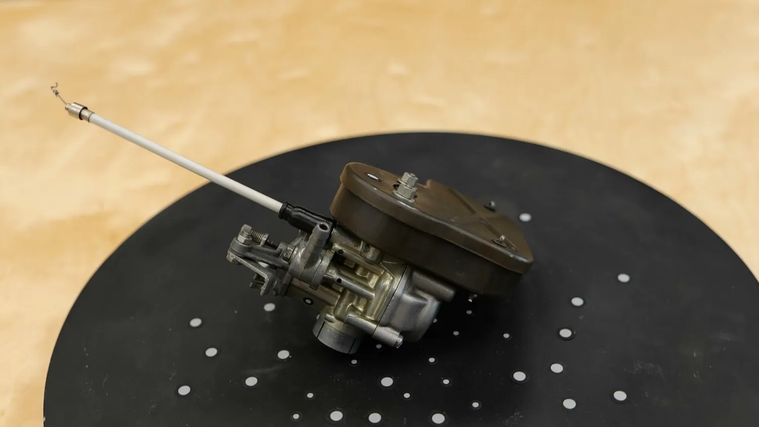 The Vespa carburetor with air filter on the turntable