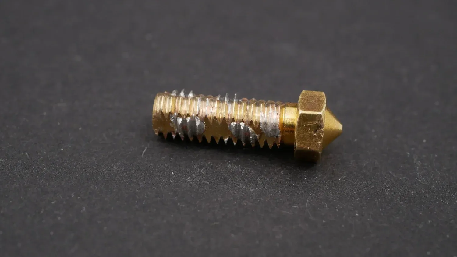 The finished Über-Volcano, its six copper wires soldered through the flow path and the threads re-cut with an M6 die