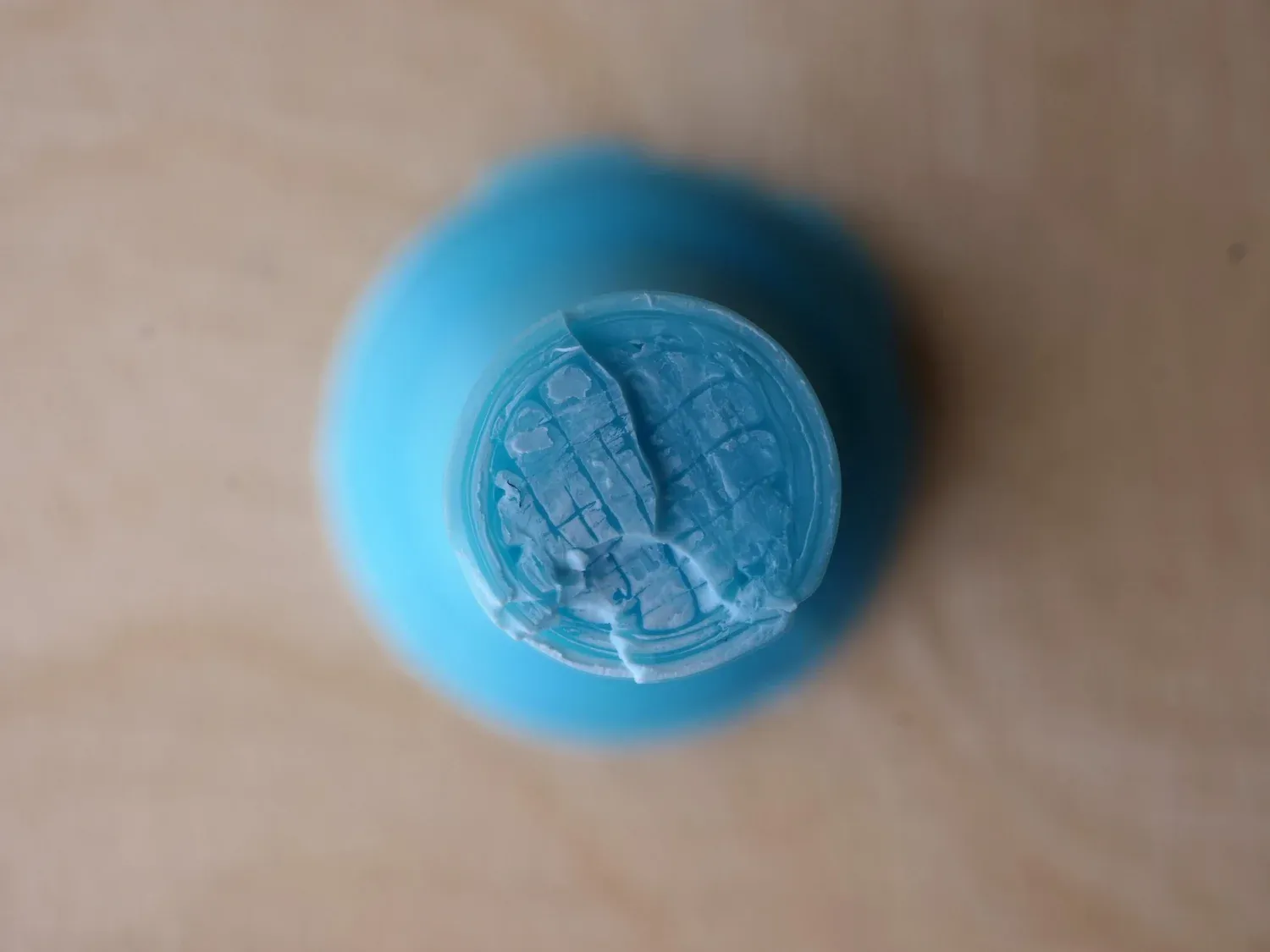 ABS from the 65 °C chamber, cracked through several layers with chunks ripped out