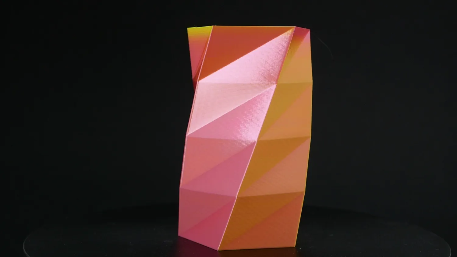 Faceted vase in pink and orange, printed in vase mode so the colour flows evenly