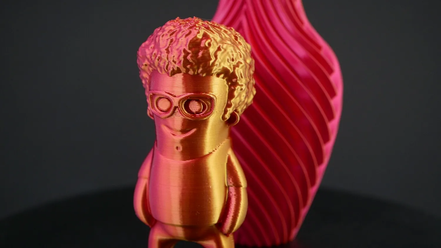 Marvin in pink and gold, in front of a matching twisted vase