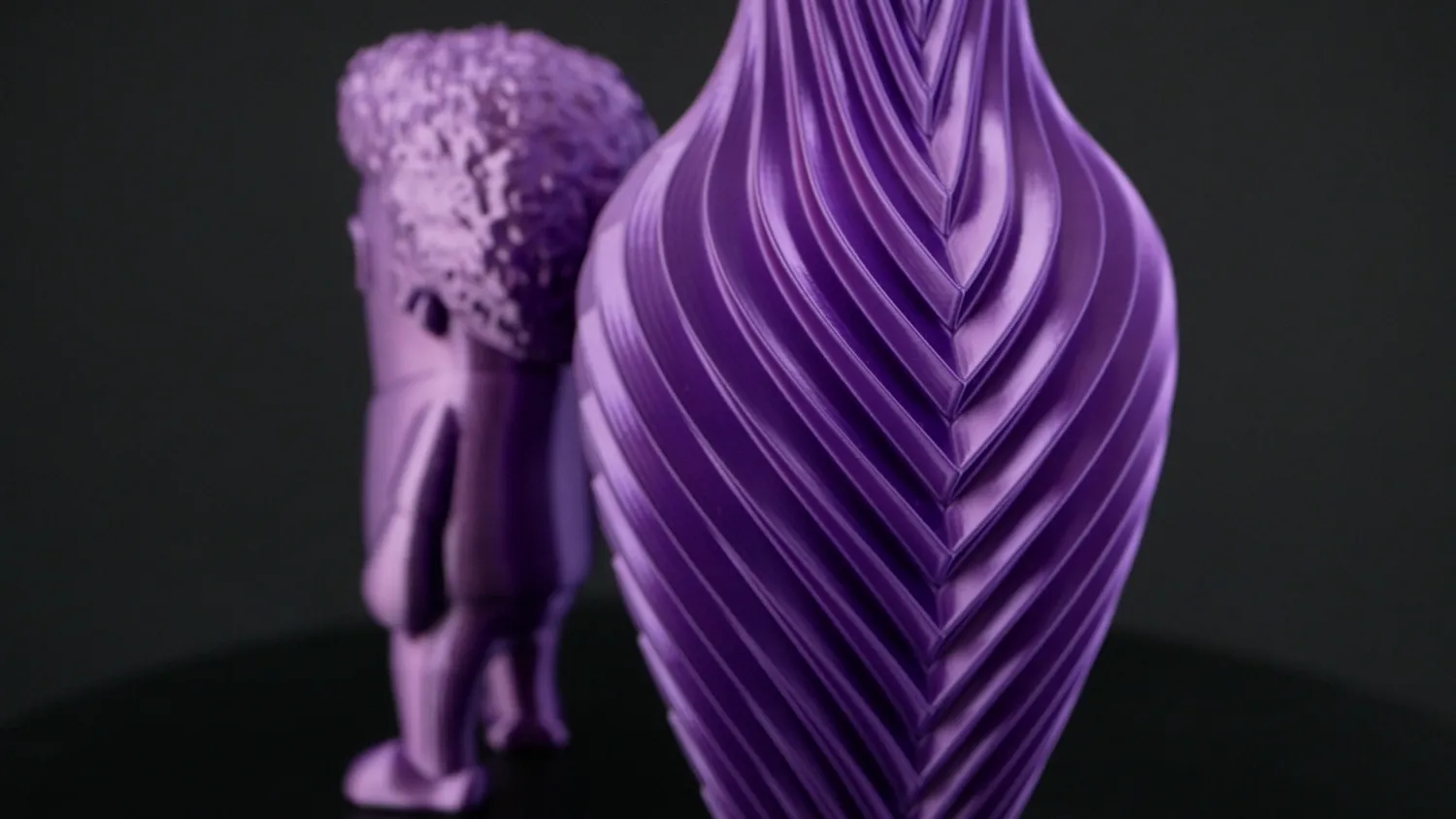 A purple vase where the twist makes the two shades alternate down each rib