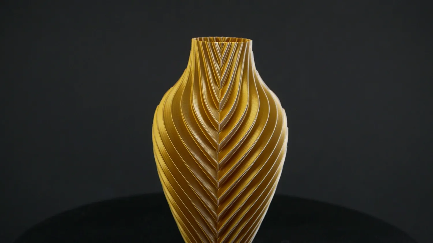 The gold and white vase alone, its twisted ribs catching the light