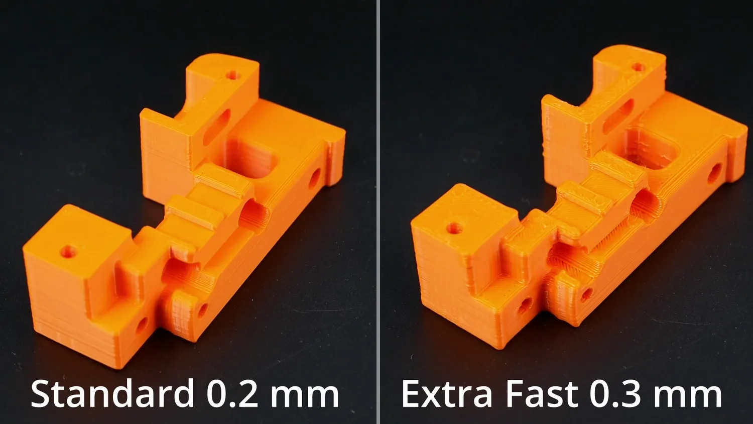 The orange benchmark part at standard 0.2 mm next to the extra fast 0.3 mm version, the fast one slightly rougher on top but free of the corner blobs
