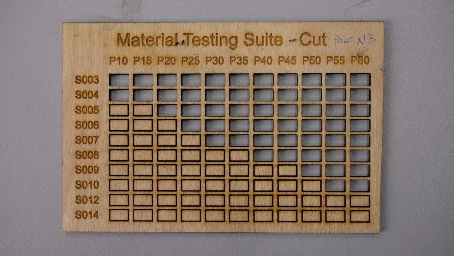 Another plywood board marked Power x1.3, cut through everywhere except the slowest column