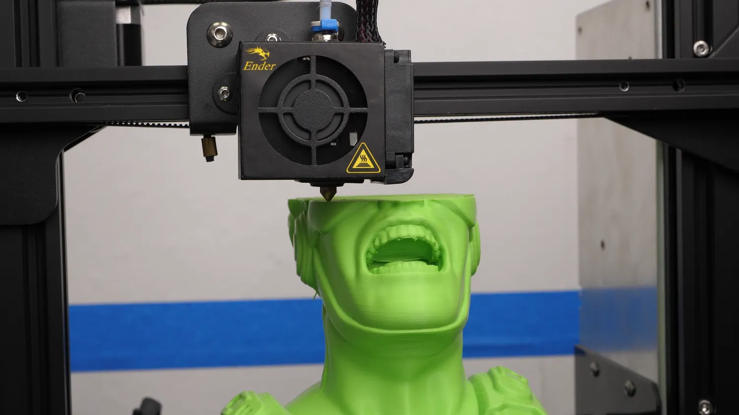 Using the printer as a CMM: the nozzle lowered in small steps until it just touches the top of the green bust