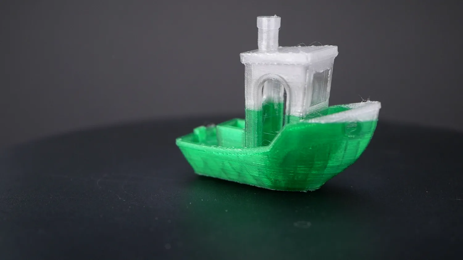 3DBenchy printed half in green and half in clear PET, with a smooth colour transition