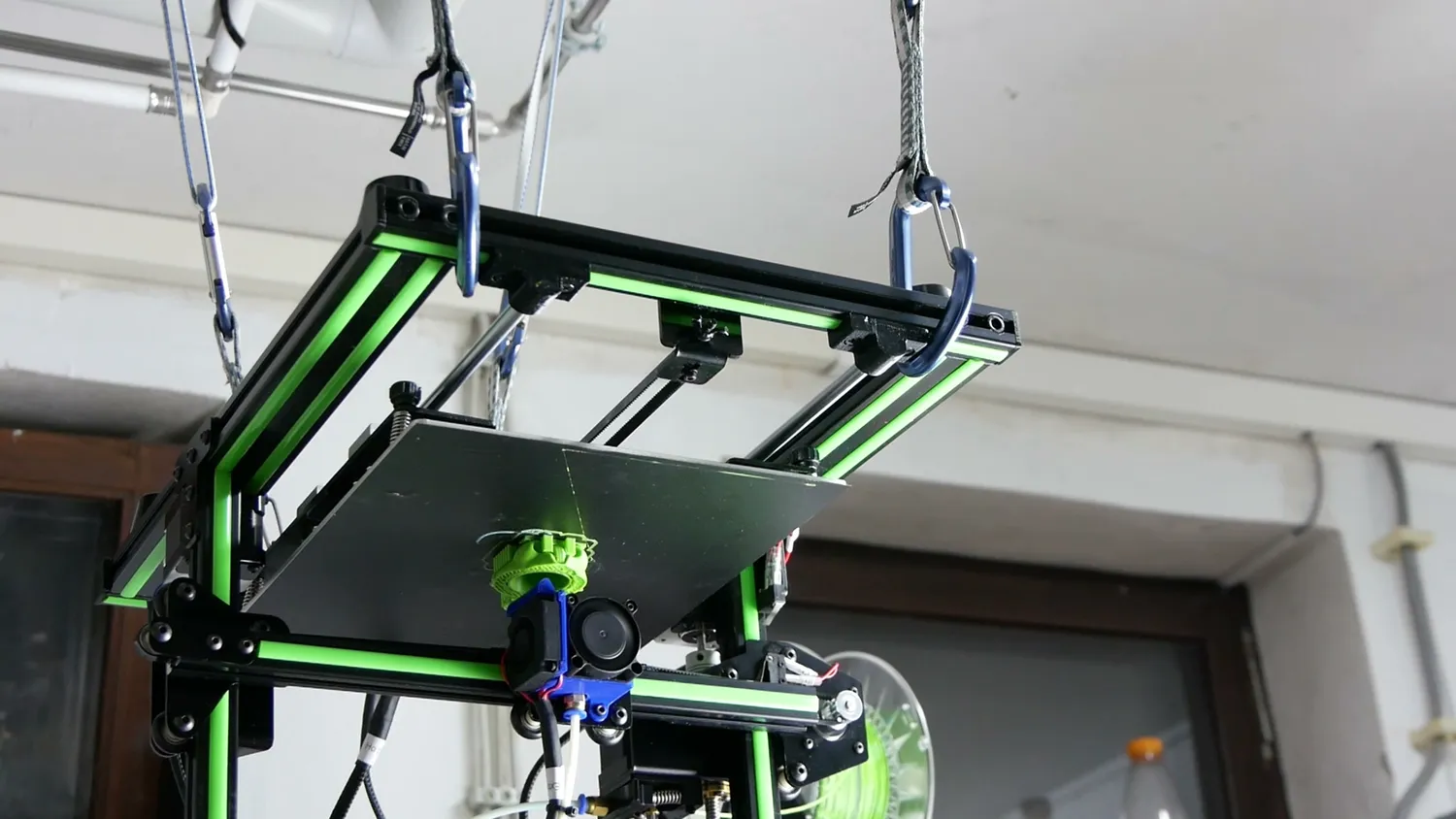 An older, slower 3D printer, printing upside down