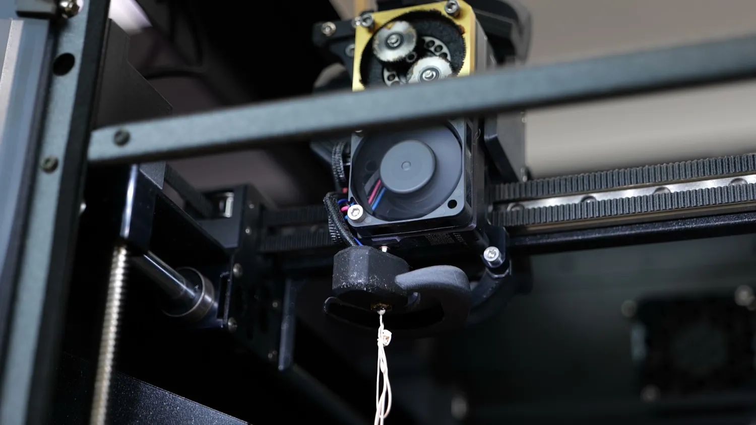 The printhead extruding filament into free air during a tuning run