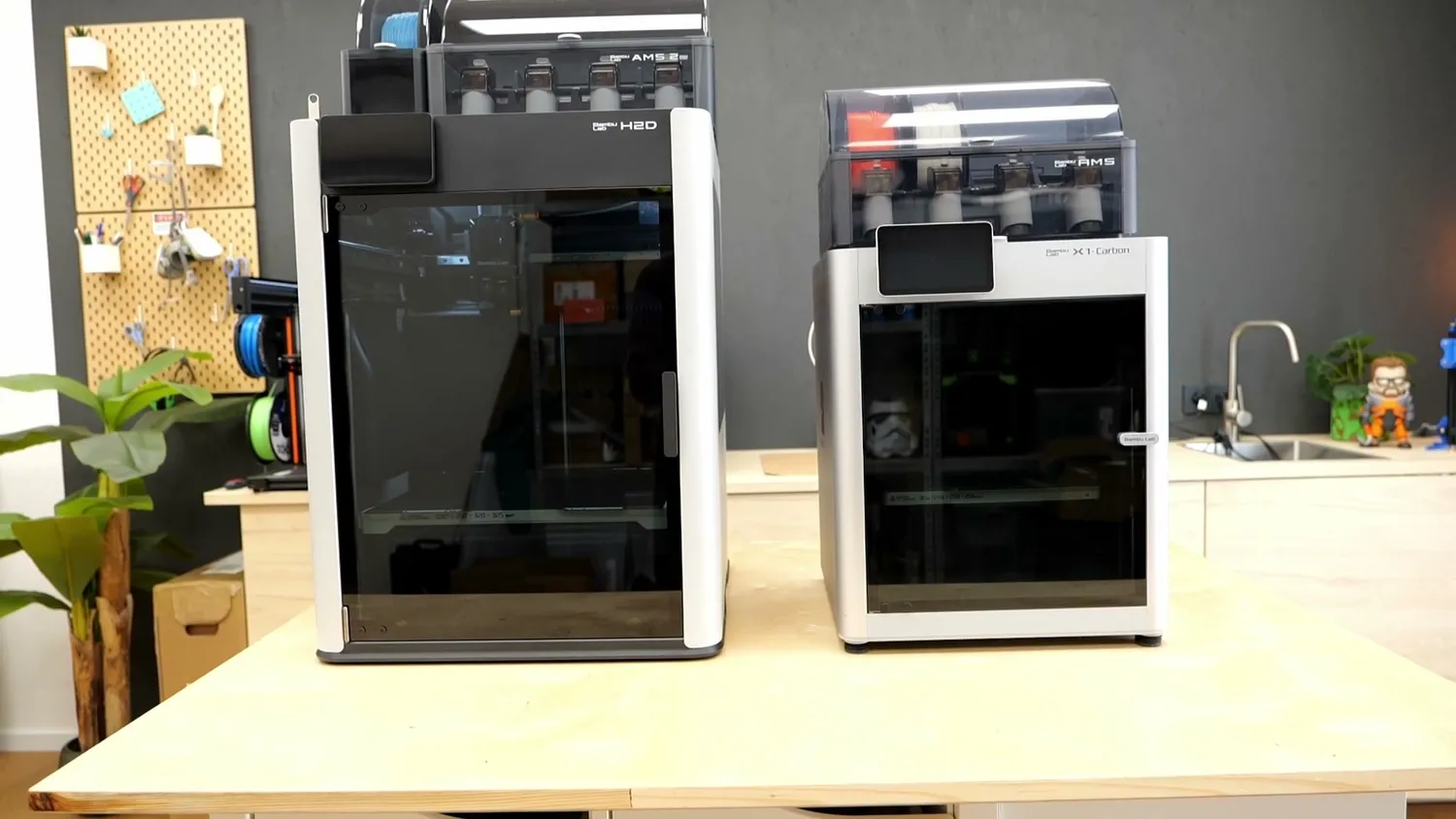 The Bambu Lab H2D next to an X1 Carbon
