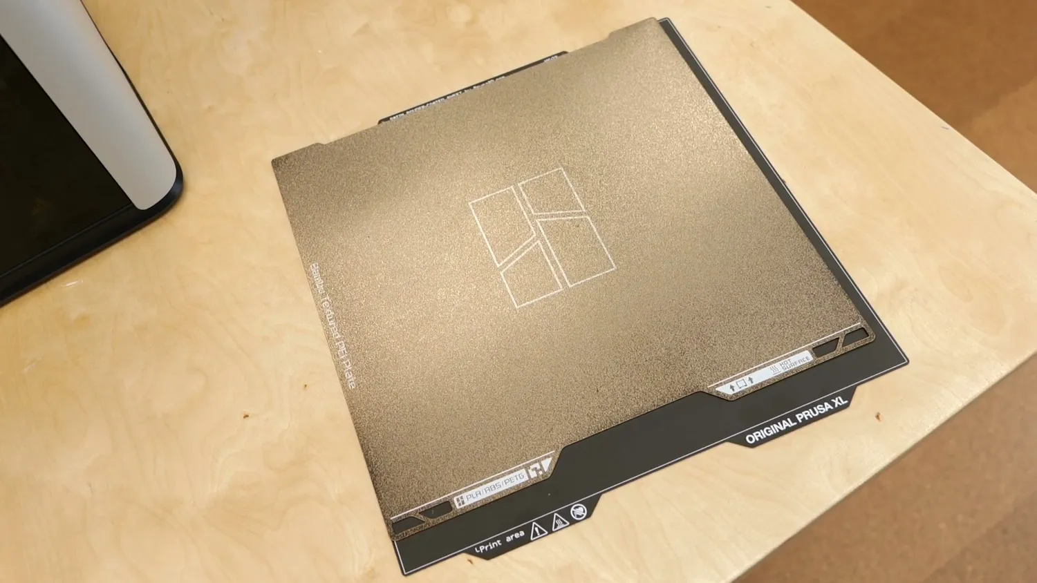 The H2D build plate next to the build plate of a Prusa XL