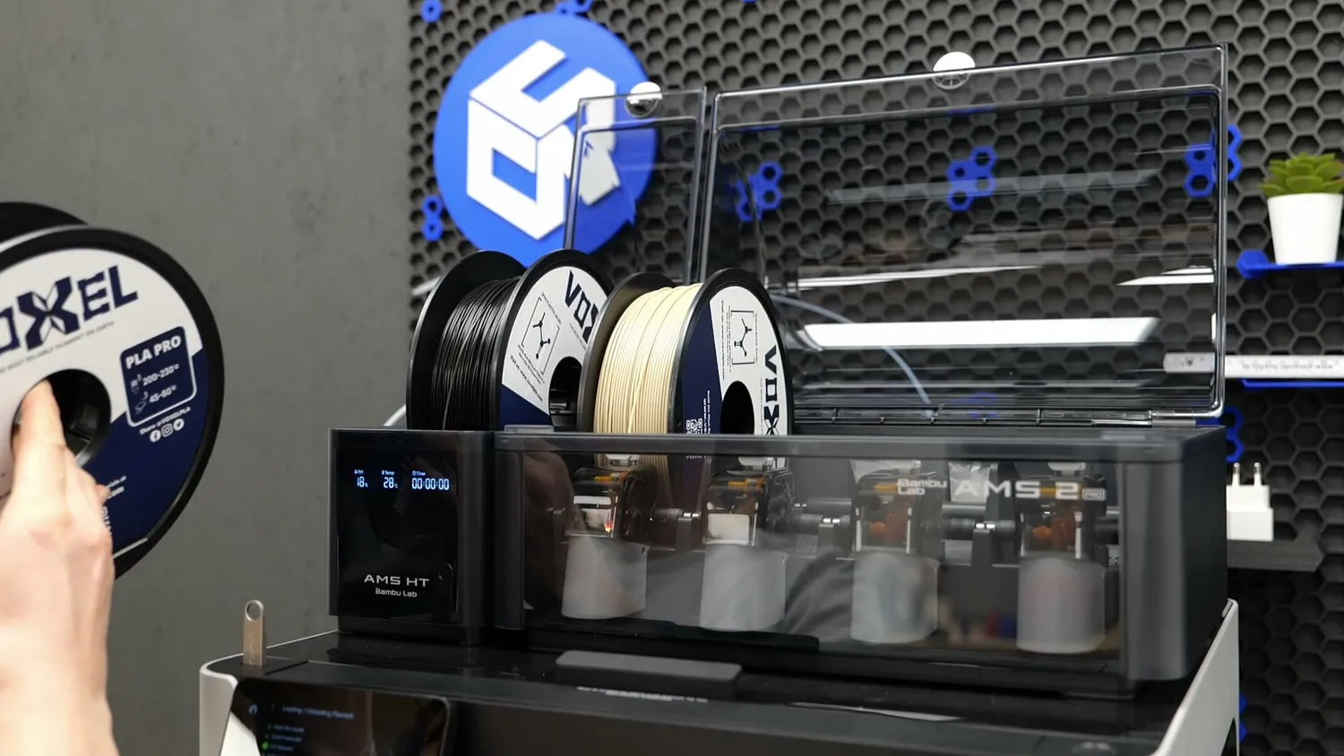 An AMS HT and an AMS 2 Pro daisy chained on top of the Bambu Lab H2D