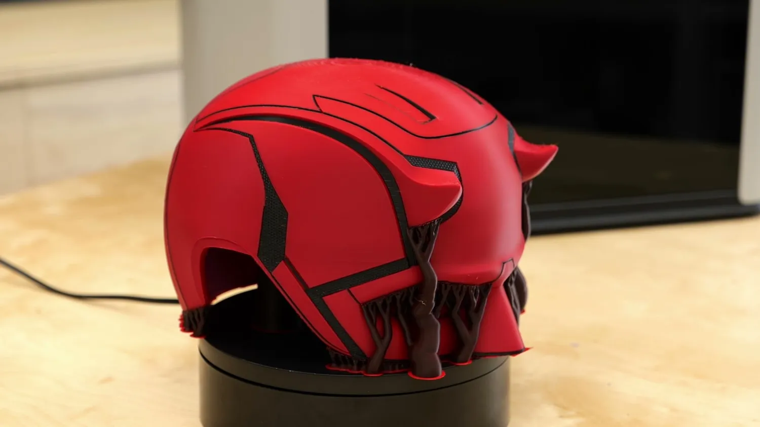 A Daredevil helmet printed in two colors on the Bambu Lab H2D