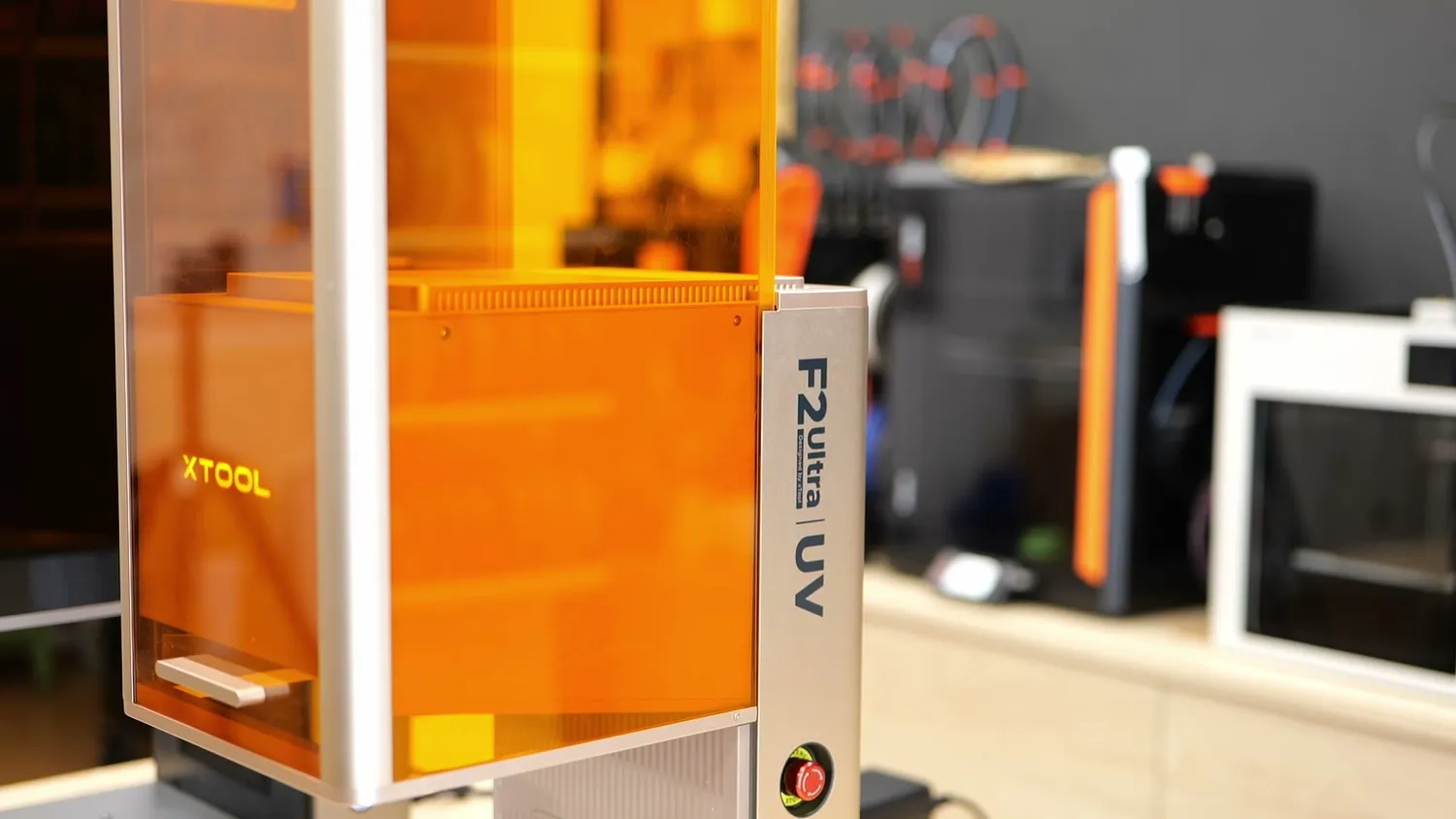 Close-up of the xTool F2 Ultra UV badge on the orange enclosure