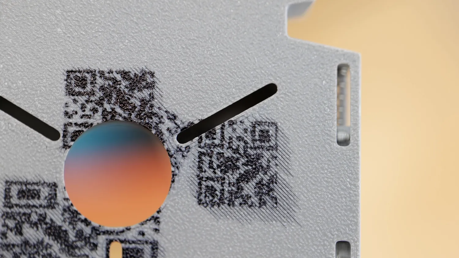 Macro of a UV printed QR code and color patch on a grey 3D printed SMD magazine