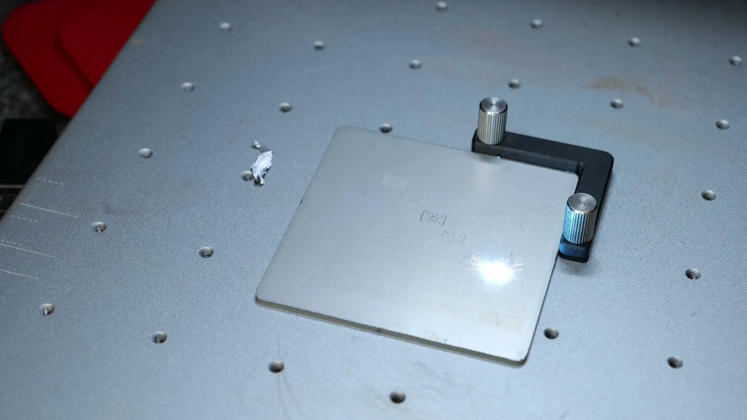 Fiber laser marking a stainless steel plate with a bright spark at the focus point