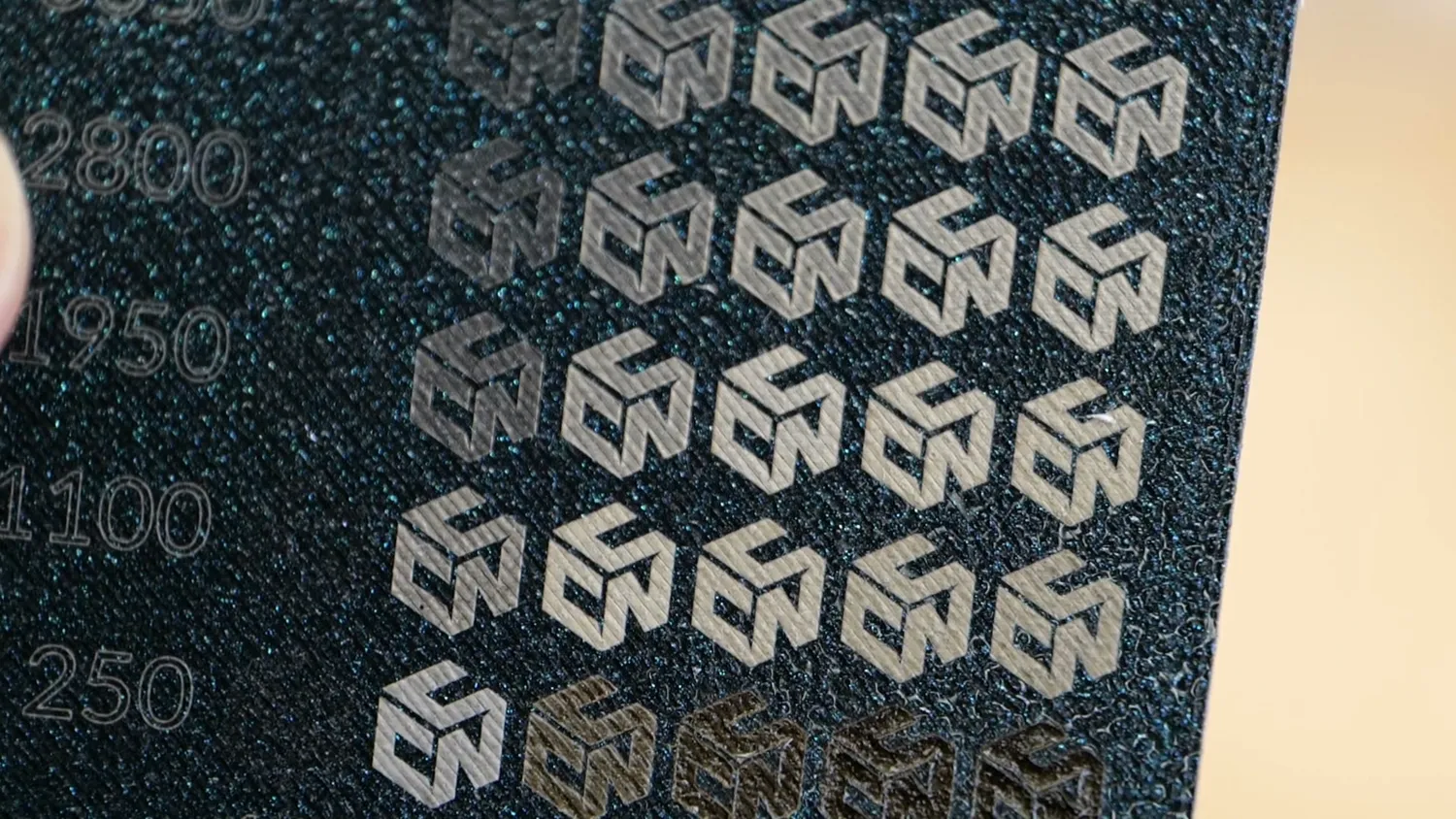 Macro of a dark blue plate with crisp grey markings after cleaning with isopropyl alcohol