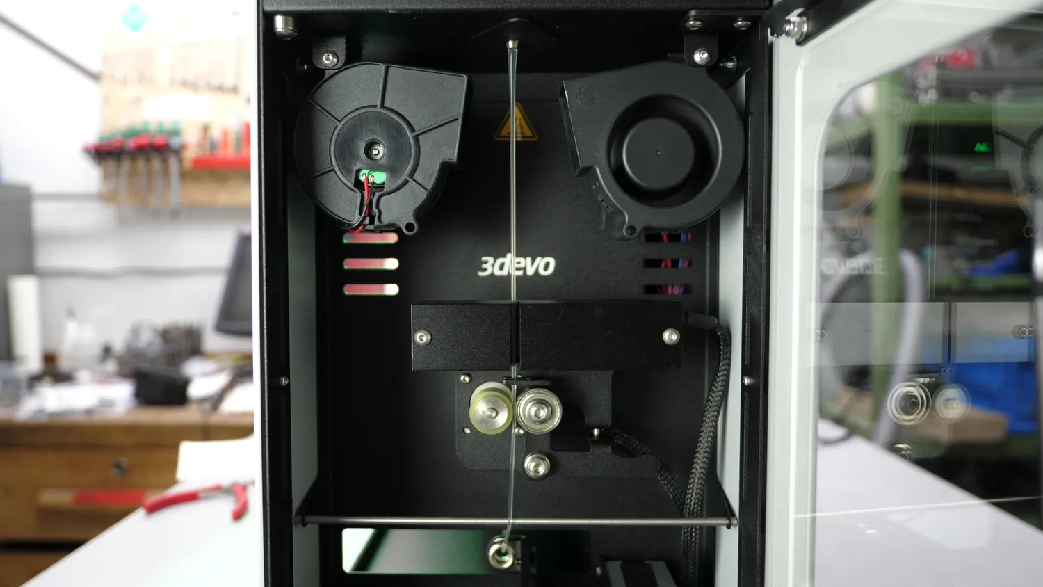  From top to bottom: Nozzle, cooling fans, optical sensor, puller wheels, positioning lug 