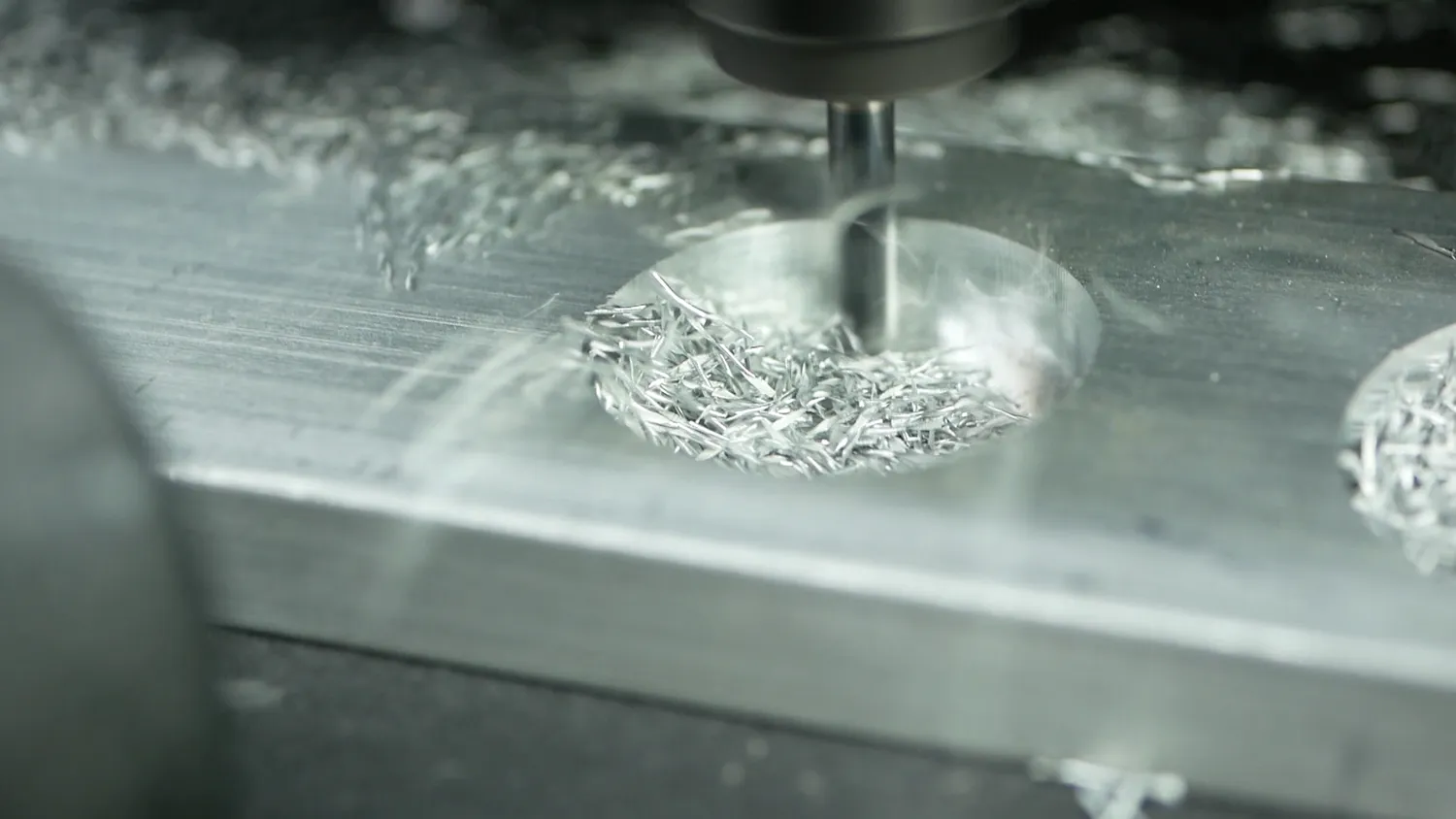 The pocket filling with bright, well-formed aluminium chips as the end mill works