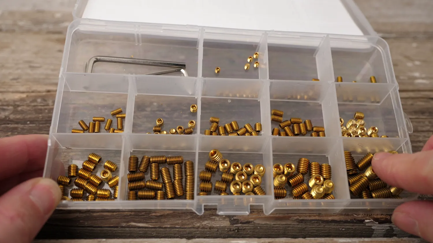 An assortment box of brass grub screws in a range of lengths, the raw material for the spacers