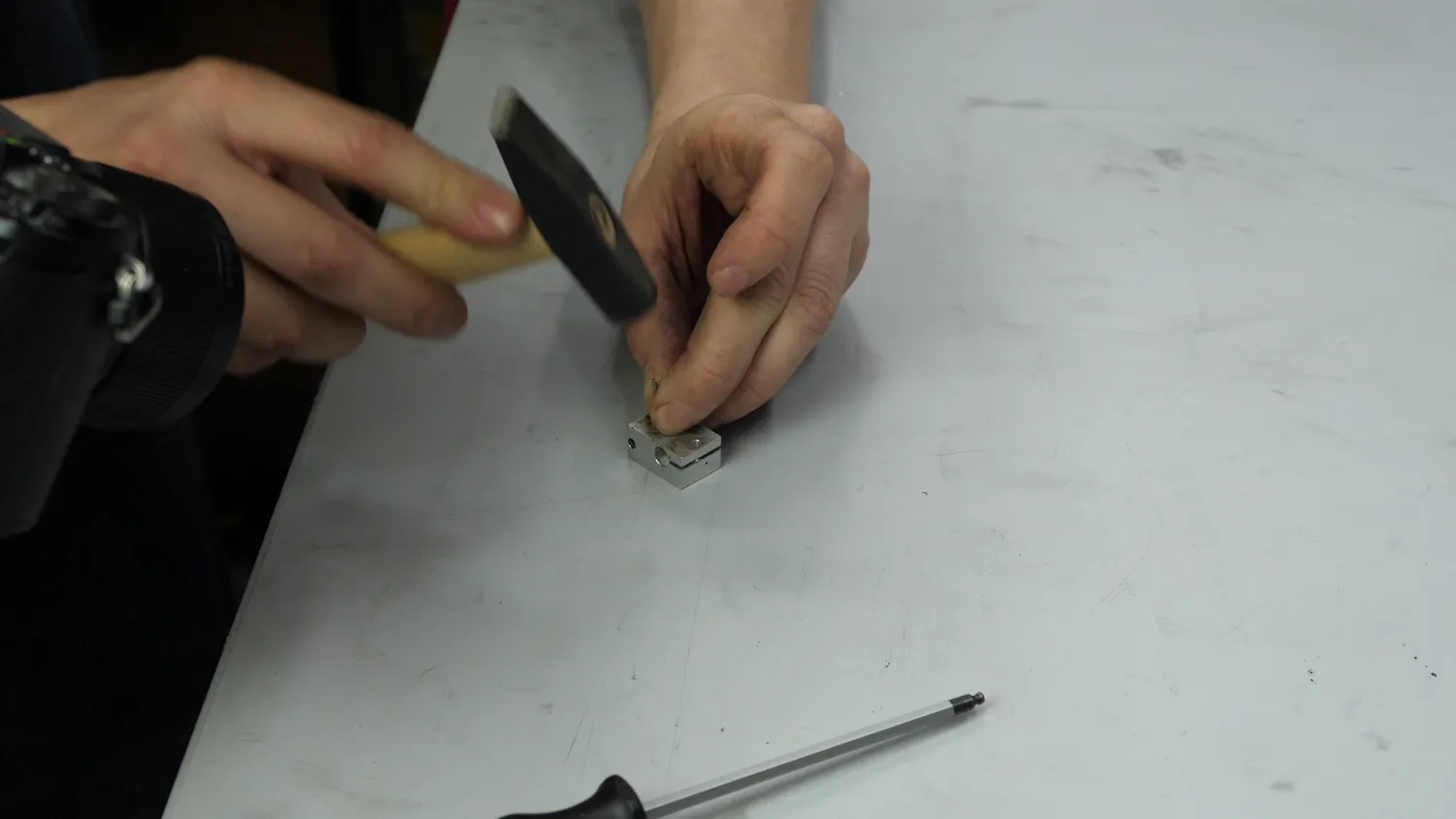 Marking the bore centres with a home-made centre punch, tapping it with a hammer