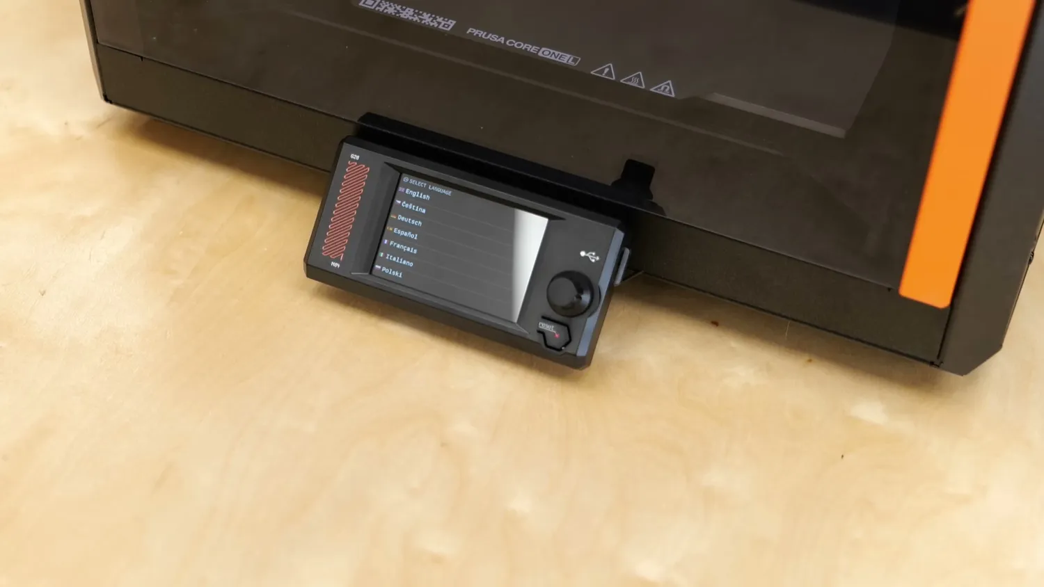 The colour LCD touchscreen mounted below the front door of the CORE One L